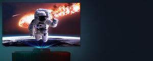 A person in a space suit is projected onto a giant TV screen using an Ultra Short Throw Projector.