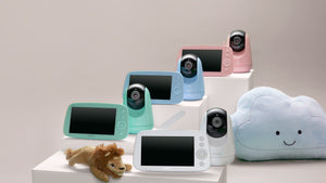 VAVA pink, blue, green, and white baby monitors and cameras with a stuffed cloud and stuffed lion toy