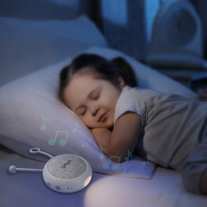 VAVA Twinkle Soother nightlight on a bed next to a sleeping toddler.