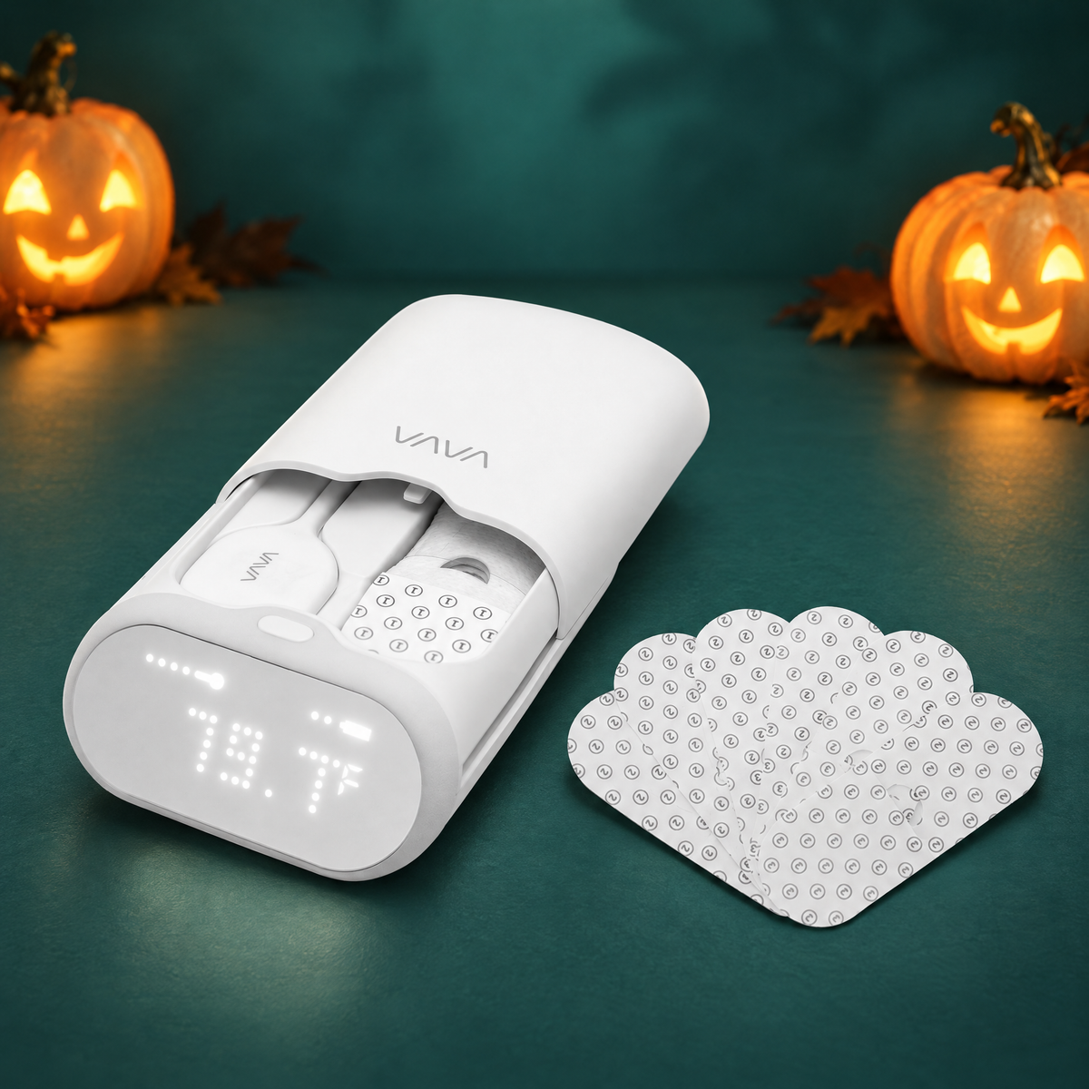 VAVA Smart Baby Thermometer with adhesive patches, Halloween bundle. Decorative pumpkins in the background.