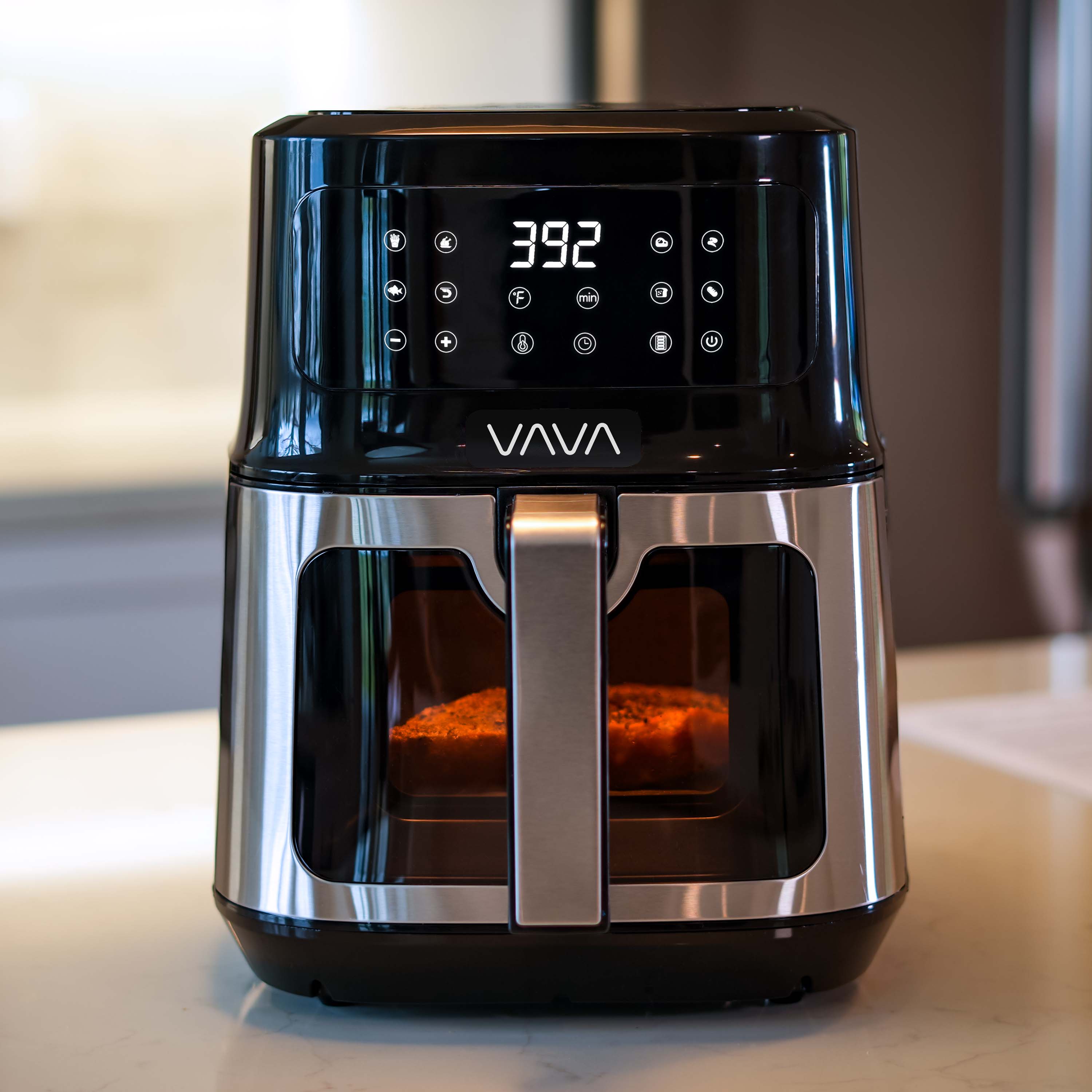 VAVA air fryer with a steak cooking inside the basket