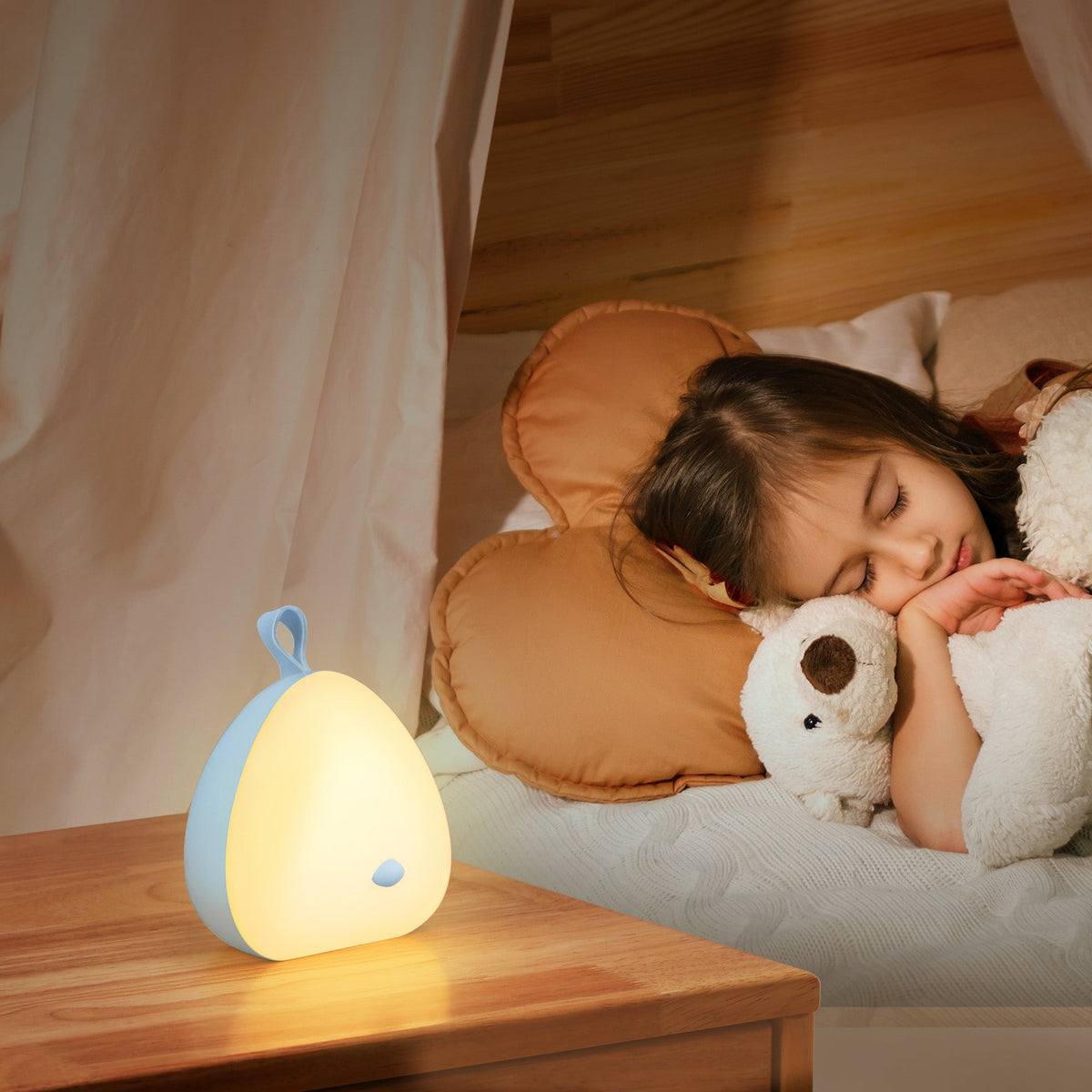 White VAVA Peep-a-Light night light glowing on a bedside table while a child sleeps.