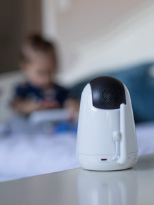 VAVA baby monitor camera directed toward a child in the background