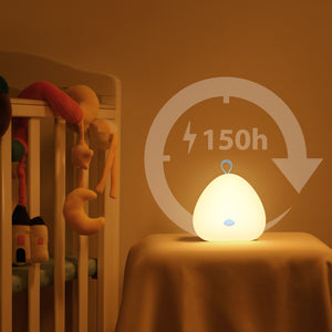 The VAVA Peep-a-Light on a night stand table next to a baby crib.