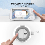 Finger pressing the ‘pair’ button on bottom of VAVA Baby Monitor Add-On Camera, finger hovering near a VAVA baby monitor screen