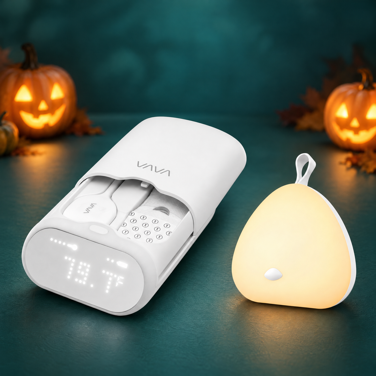 VAVA Smart Baby Thermometer with White (Standard) Peep-a-Light night light, Halloween bundle. Decorative pumpkins in the background.