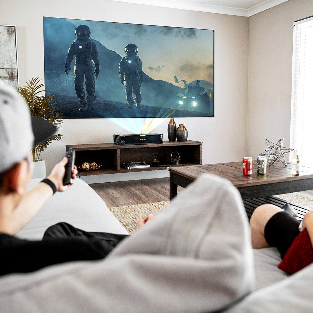 The VAVA Chroma triple laser projector and projector screen in a home theater setting