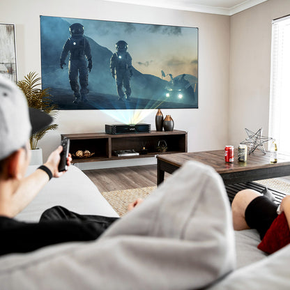 The VAVA Chroma triple laser projector and projector screen in a home theater setting