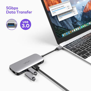 VAVA 9-in-1 USB-C Hub connected to a laptop computer, a USB 3.0 drive, and a black cable near a second USB 3.0