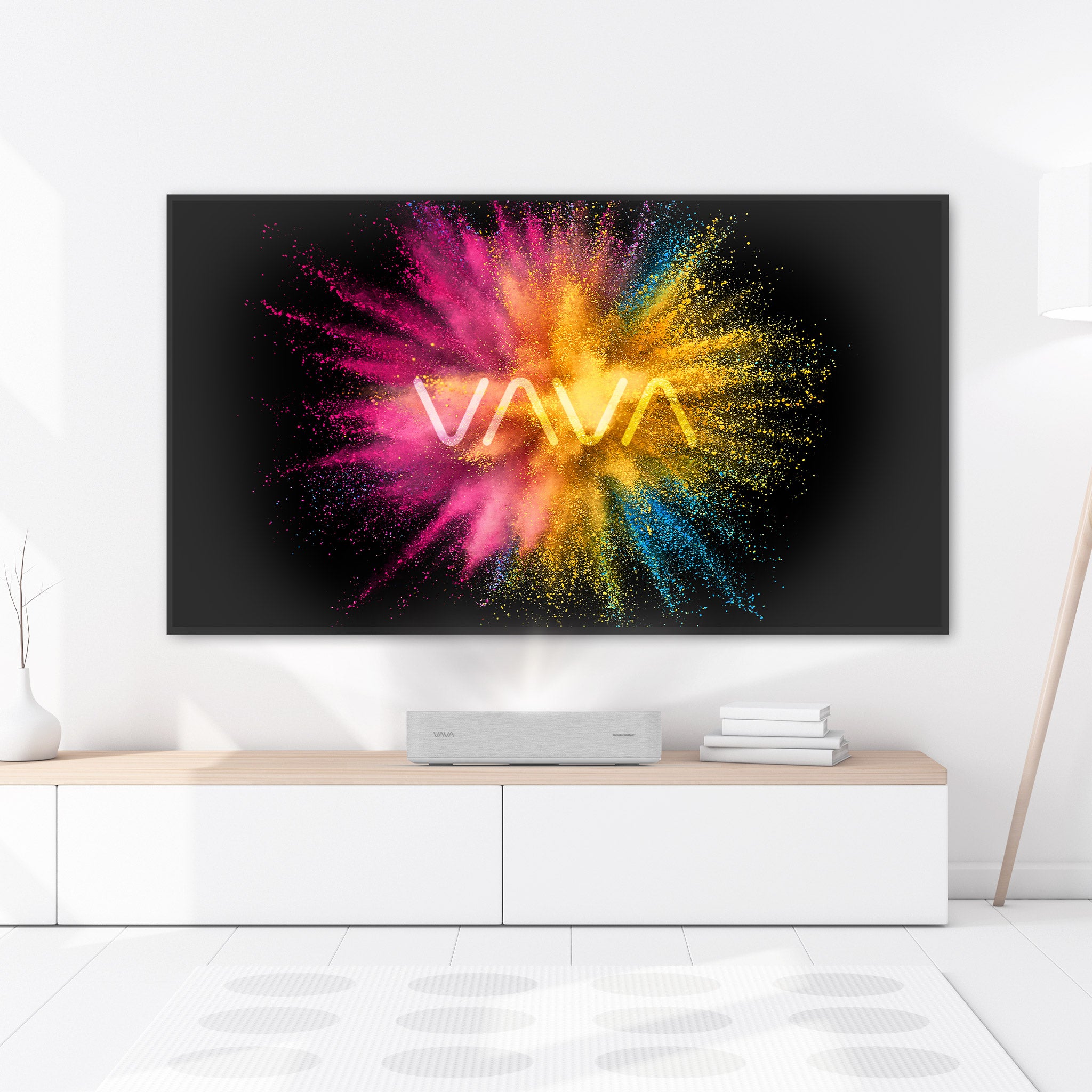 VAVA 4K Laser TV projector on a white and wood table, ALR screen pro with the VAVA logo on the screen
